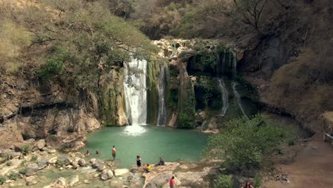 Tourists-Swimming-At-Natural-Pool-Of-Cascada-de-Comala-Park-In-Chiquilistlan,-Jalisco,-Mexico