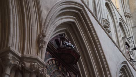 Wells-Cathedral-wall-clock-with-their-horses-circulating-when-they-hit-the-time,-camera-still-4K