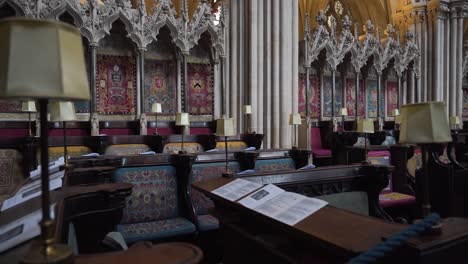 Wells-Cathedral-posh-seating-area,-wooden-seating-and-decorated-walls