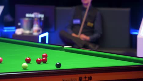 John-Higgins,-a-Scottish-professional-snooker-player,-plays-a-shot-as-he-strikes-a-ball-during-a-match-of-the-Hong-Kong-Masters-snooker-tournament-event