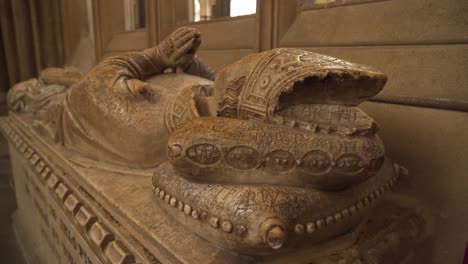 Close-up-on-one-of-the-vandalised-effigies-of-the-Saxon-bishops-of-the-wells-cathedral,-camera-rotating-to-the-right-showing-the-back-of-the-effigy