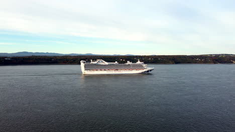 Drone-view-of-the-Caribbean-Princess-cruise-ship-over-the-Saint-Lawrence-River,-from-the-south-shore-of-Quebec-city