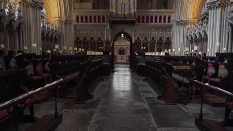 Wells-Cathedral-interior,-camera-rotating-to-the-left-showing-some-of-the-wooden-benches-where-people-seat-to-do-their-prays