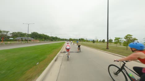 Chicago-cyclists-riding-northbound-on-DuSable-Lake-Shore-Drive-during-Bike-the-Drive-2022-red-triathlon-triathlete-time-trial-bike-south-side-merging-into-main-road