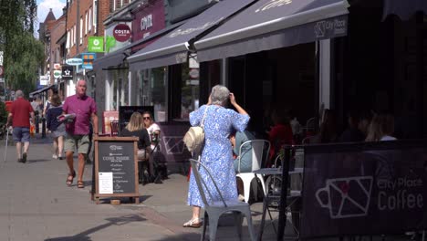Wanstead-High-Street-and-City-Place-coffee-shop-with-shoppers-walking-past-on-a-sunny-day