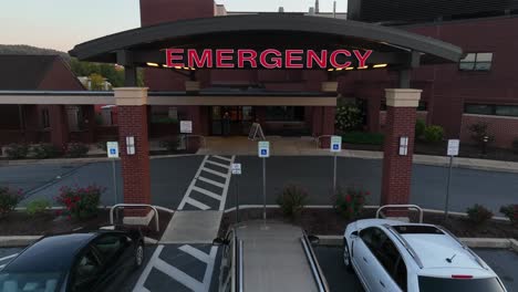 Zoom-in-aerial-drone-shot-of-emergency-sign-at-emergency-room-in-nice-hospital-building