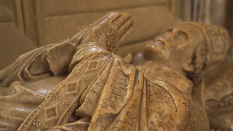 Close-up-on-one-of-the-vandalised-effigies-of-the-Saxon-bishops-of-the-wells-cathedral,-camera-rotating-to-the-right-showing-the-vandalised-parts-of-the-effigy