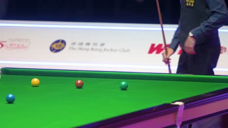 John-Higgins,-a-Scottish-professional-snooker-player,-strikes-a-ball-during-a-match-of-the-Hong-Kong-Masters-snooker-tournament-event