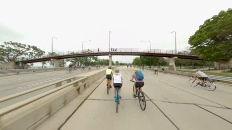 Chicago-cyclists-riding-southbound-on-DuSable-Lake-Shore-Drive-during-Bike-the-Drive-2022-biking-under-pedestrian-bridge-cyclist-waves