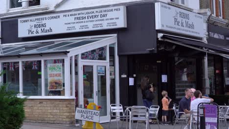 Robins-Pie-and-Mash-shop-in-Wanstead-High-Street-with-people-sitting-eating