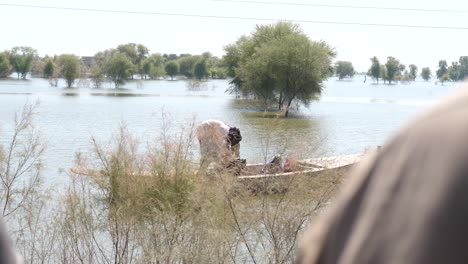 Pair-Of-Adults-Seen-On-Boat-Floating-On-River-In-Maher,-Sindh,-Pakistan