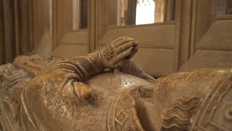 Close-up-on-one-of-the-vandalised-effigies-of-the-Saxon-bishops-of-the-wells-cathedral,-camera-rotating-to-the-left-showing-the-the-hands-of-the-effigy