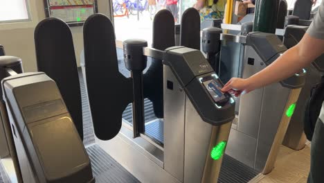 Passenger-at-the-gated-entrance-in-South-Brisbane-station,-touching-off-by-tapping-the-go-card-on-the-card-reader-machine,-error-message-has-occurred,-successfully-touch-off-on-the-second-try