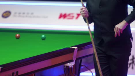 John-Higgins,-a-Scottish-professional-snooker-player,-hits-a-ball-during-a-match-of-the-Hong-Kong-Masters-snooker-tournament-event