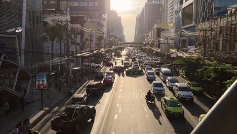 Traffic-jam-and-slowly-moving-vehicles-on-Sukhumvit-road-in-Bangkok-at-sunset