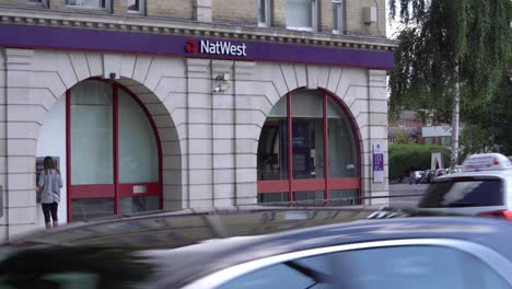 A-person-taking-money-out-of-a-cash-machine-at-Natwest-bank-in-Wanstead-High-Street