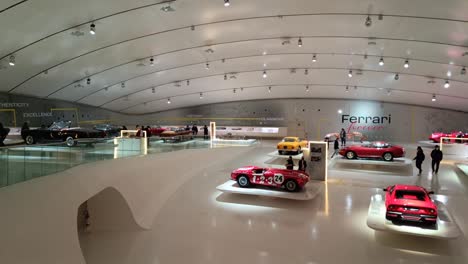 Tourists-in-Museum-Enzo-Ferrari-Modena-observing-displayed-Italian-supercars