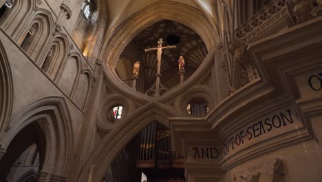 Wells-Cathedral-eight-shape-wall-with-a-crucifix-on-the-top,-camera-moving-to-the-left-4K