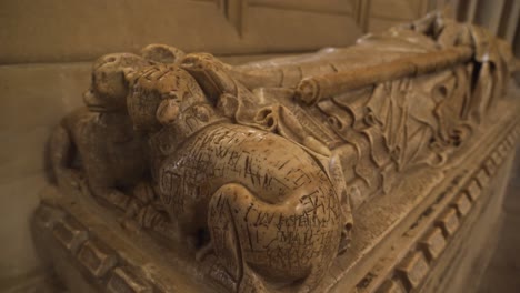 Close-up-on-one-of-the-vandalised-effigies-of-the-Saxon-bishops-of-the-wells-cathedral,-camera-rotating-to-the-right-showing-the-vandalised-parts-of-the-effigy