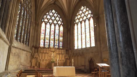 Wells-Cathedral-stained-glass-windows,-camera-moving-to-the-left-showing-some-of-the-windows-and-the-columns