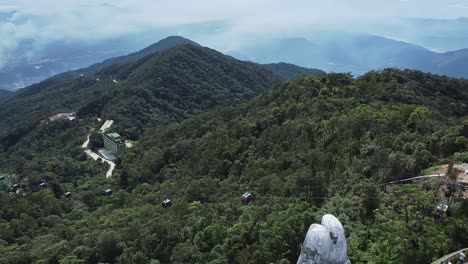 Aerial-View-Of-Forested-Da-Nang-Ba-Na-Hills-With-Dolly-Back-To-Reveal-The-Giant-Hand-Bridge