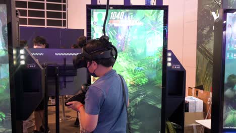 A-young-Chinese-gamer-plays-a-Virtual-Reality-shooting-videogame-as-he-turns-around-to-find-a-target-during-the-Hong-Kong-Computer-and-Communications-Festival-in-Hong-Kong
