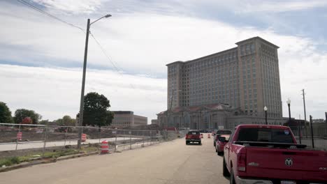 Michigan-Central-Station-in-Detroit,-Michigan-with-gimbal-video-walking-past-vehicles