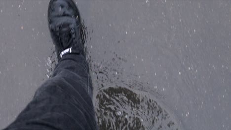 Pov-Persona-Caminando-Por-Vía-Húmeda-Inundada-Durante-La-Tormenta-De-Lluvia-De-Arriba-Hacia-Abajo