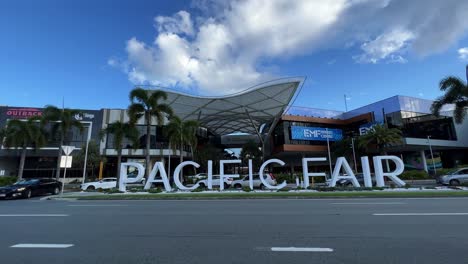 Establishing-static-shot-of-the-block-letter-sign-at-the-front-entrance-of-pacific-fair-shopping-centre-against-blue-sky-with-car-traffics-in-the-foreground-on-a-sunny-day