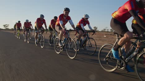 Wide-tracking-shot-of-a-group-of-cyclists-during-a-competition