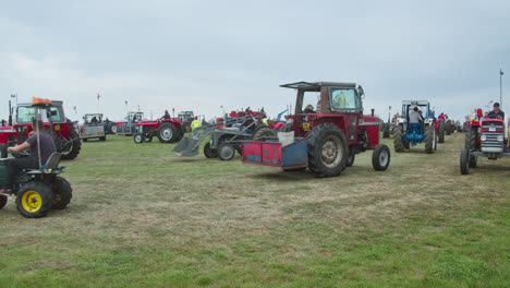 Various-Vintage-Agricultural-Tractors-Driving-Around-At-The-Field-During-Great-Trethew-Vintage-Rally-In-Liskeard,-UK