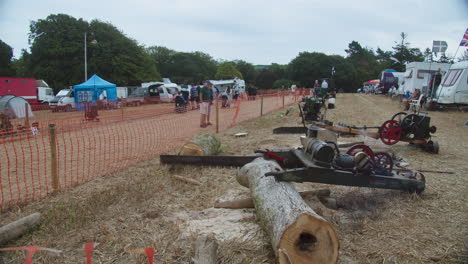 Engine-powered-Antique-Drag-Saw-Cutting-Tree-Logs-At-The-Great-Trethew-Rally-In-Liskeard,-UK