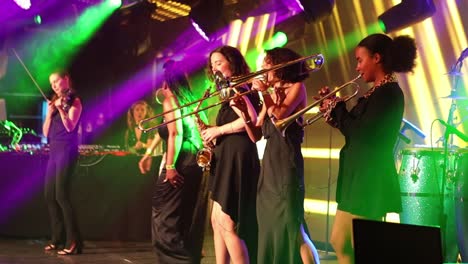 All-Female-Band-Performing-On-Stage-In-London-singing-and-playing-the-trumpet,-United-Kingdom