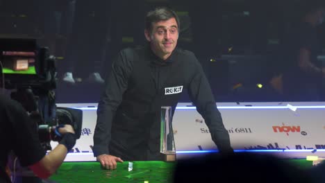 World-champion-and-world-number-one-snooker-player,-Ronnie-O'Sullivan,-poses-with-the-winner-trophy-as-he-celebrates-the-championship-victory-at-the-Hong-Kong-master-tournament-competition-event