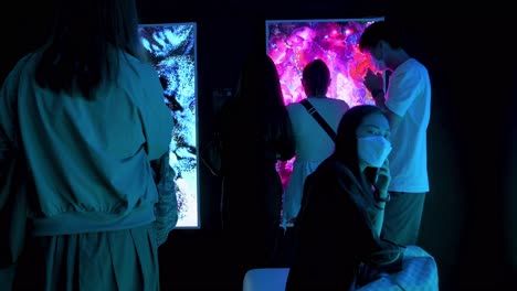 Chinese-visitors-stand-in-front-of-an-art-installation-at-the-Digital-Art-Fair-showcasing-upcoming-trends-such-as-Web-3