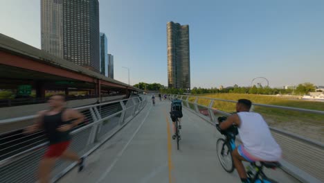 Northbound-time-lapse-of-bike-ride-on-Chicago's-Lakefront-trail-on-the-shores-of-Lake-Michigan-cycling-traffic-transportation-running-crowd-sunset