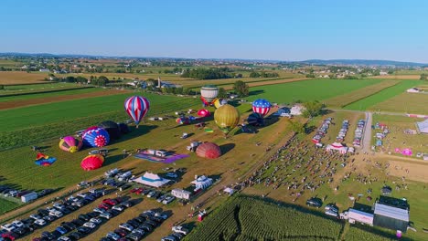 Bird-in-Hand,-Pennsylvania,-September-19,-2021---Drone-View-of-Hot-Air-Balloons-Launching-During-a-Balloon-Festival-in-a-Sunny-Sky