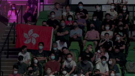 Local-spectators-hold-a-Hong-Kong-flag-as-they-watch-a-snooker-match-during-the-Hong-Kong-Masters-snooker-championship-tournament-event