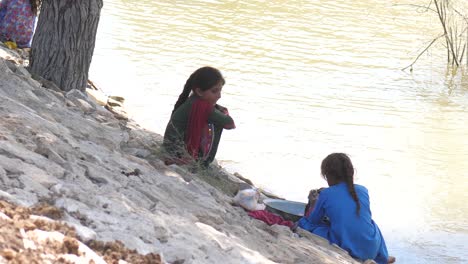 Young-Girl-Doing-The-Washing-Beside-River-In-Maher,-Sindh