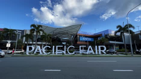 Static-shot-capturing-the-block-letter-sign-at-the-front-entrance-of-pacific-fair-shopping-centre-with-car-traffics-in-the-foreground-on-a-sunny-day