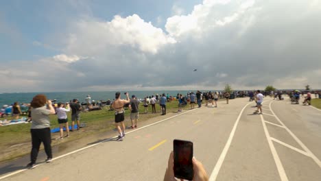 F-35-fighter-jet-flies-past-crowd-of-observers,-runners,-and-cyclists-on-Lakefront-Trail-at-the-2022-Chicago-Air-and-Water-Show