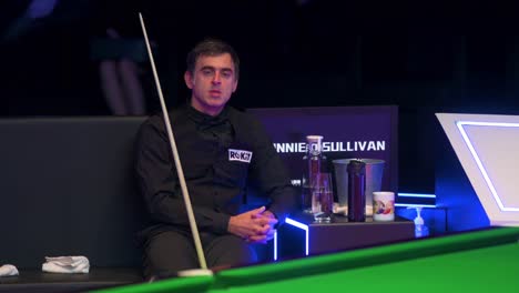 English-snooker-player-Ronnie-O'Sullivan,-World-Champion,-rests-and-looks-on-between-sets-at-a-match-against-female-player-Ng-On-Yee-during-the-Hong-Kong-Masters-snooker-tournament