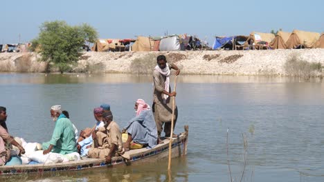 A-static-shot-of-rescue-team-shift-flood-affected-people-towards-safe-place-on-boat-during-rescue-operation-at-a-flood-affected-area-in-Sindh