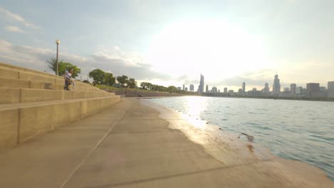 Northbound-time-lapse-of-bike-ride-on-Chicago's-Lakefront-trail,-from-Adler-Planetarium-to-Navy-Pier,-on-the-shores-of-Lake-Michigan-Adler-Planetarium-Big-City-Skyline-Urban-Loop-Downtown-Cycling