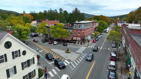 Rising-aerial-shot-of-town-square-with-historic-buildings,-local-businesses,-and-family-homes