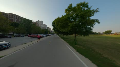 Northbound-time-lapse-of-bike-ride-on-Chicago's-Lakefront-trail-on-the-shores-of-Lake-Michigan-traffic-sunset-commute-dusk