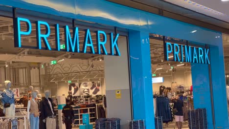 Storefront-of-Primark,-famous-fast-fashion-chain-at-La-Canada-shopping-mall-in-Marbella-Spain,-people-looking-around-and-shopping,-4K-shot