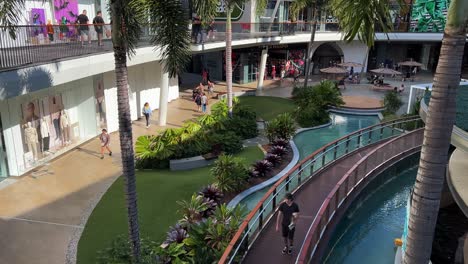 Shoppers-strolling-and-window-shopping-at-pacific-fairs-shopping-centre-in-Gold-Coast,-Broadbeach,-quiet-mall-due-to-inflation-hike,-people-with-less-purchasing-power