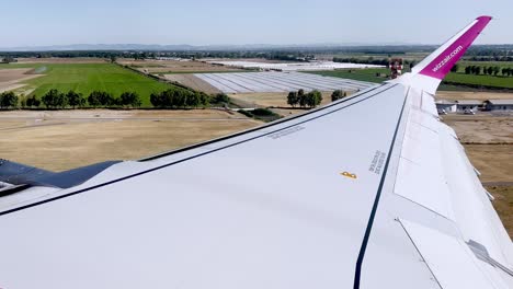 Second-part-of-passenger-point-of-view-of-Wizzair-aircraft-wing-during-take-off-from-Rome-Fiumicino-Airport-runway,-Italy