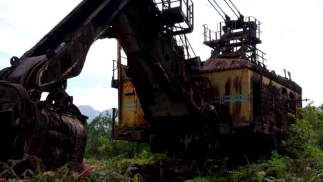 Heavy-machinery-mining-crane-abandoned-within-closed-copper-and-gold-Pangua-Mine-in-central-Bougainville,-Papua-New-Guinea